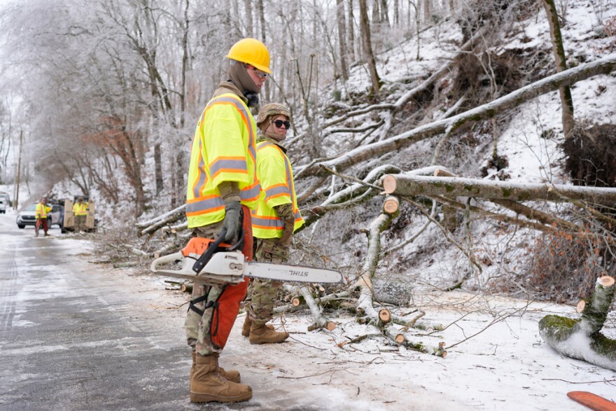 Tennessee National Guard Specialist Taylor Osteen, left, holds a chainsaw as he takes a break from cutting trees from a road Friday, Jan. 30, 2026, in Nashville, Tenn.