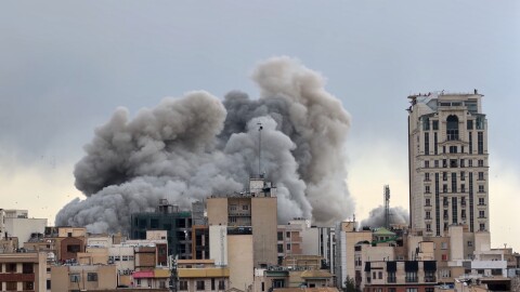 A plume of smoke rises after a strike in Tehran, Iran, Monday, March 2, 2026.