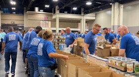 Food Lion volunteers pack boxes for food insecure families. 