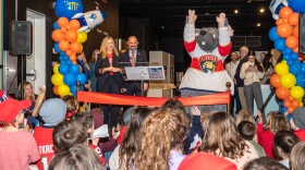 A rat mascot excited a crowd of children at a ribbon cutting ceremony