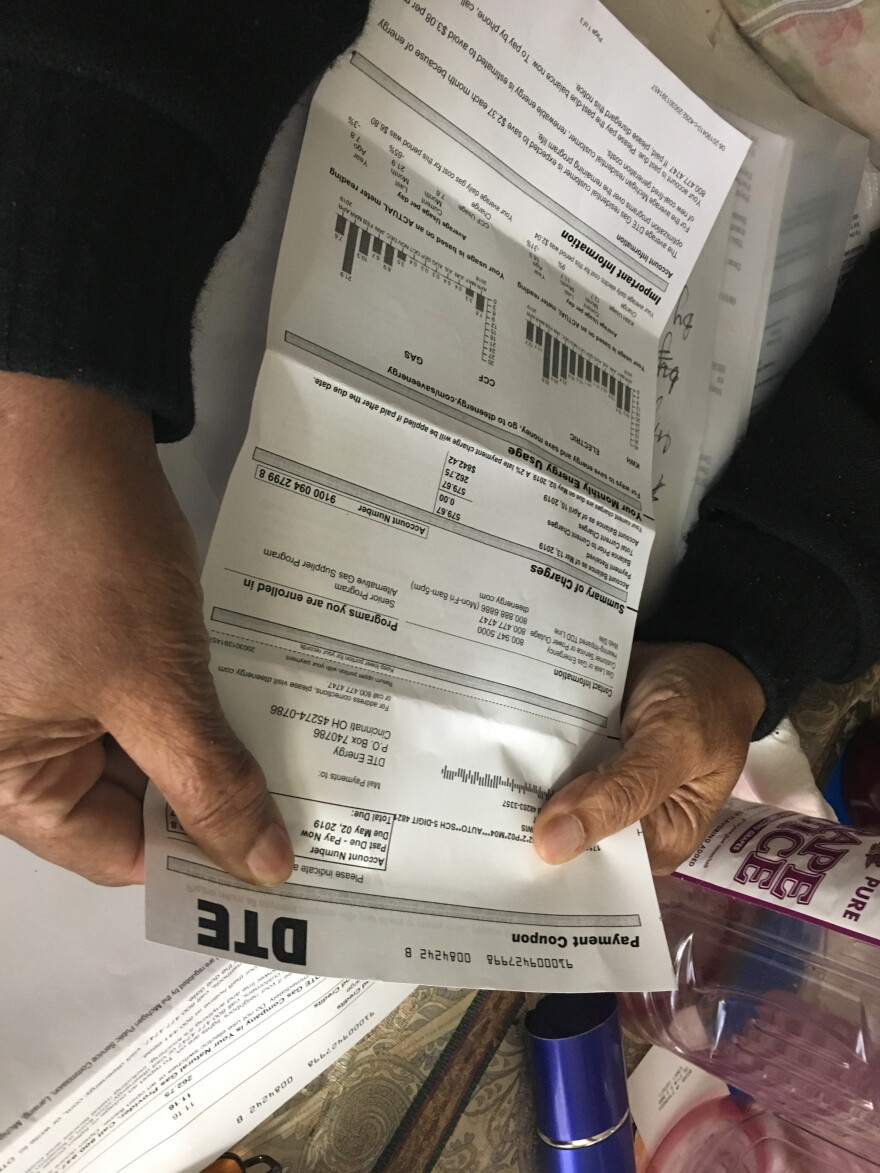 Margaret Lewis examines her latest utility bill from DTE Energy.