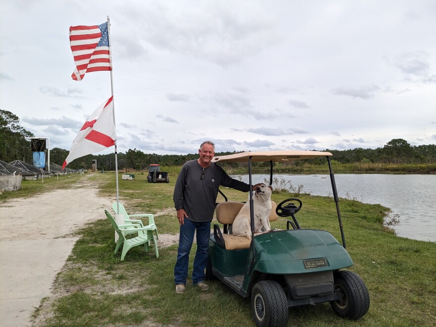 At Evans Farms, Geno Evans poses for a photo with one of the family’s beloved dogs, Myra, who prefers sitting in the driver’s seat.