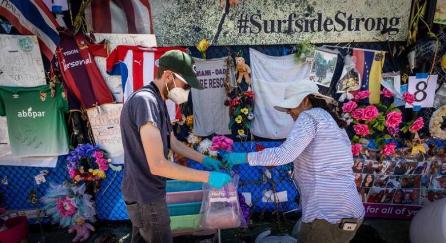 Workers for HistoryMiami bag items to be preserved from the Surfside memorial on Monday, August 30, 2021.