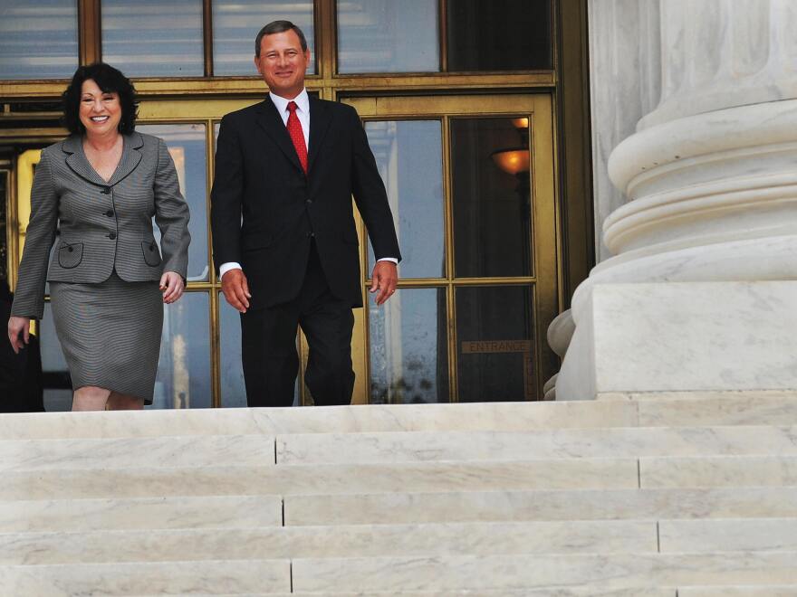 Chief Justice John Roberts and Associate Justice Sonia Sotomayor exit the front entrance of the Supreme Court building following Sotomayor's investiture ceremony in 2009.