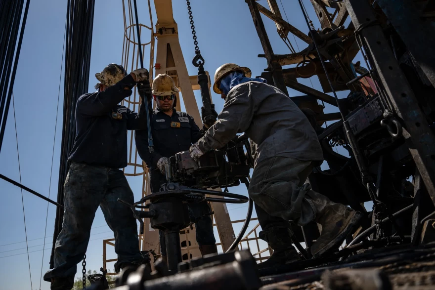 A service rig crew pulls sucker rods from an oil and gas well as they work to bring a downhole pumping unit to the surface on Aug. 14, 2024, in West Odessa.