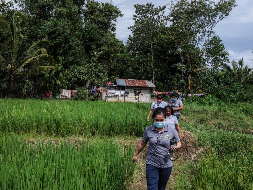 Marissa Tuping, a rural midwife and health-care worker, walks to visit pregnant mothers in the village of Abinganan.