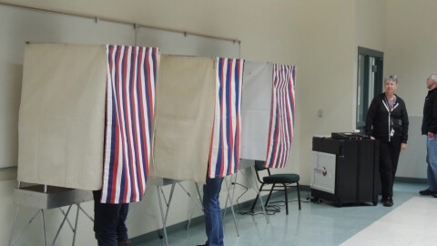 Voters fill out their ballots at the District 2 polling location on Aug. 16.