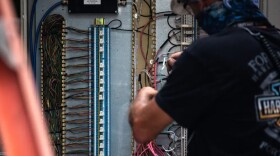 A power plant employee adjusts the wiring of a power unit in North Texas. The Texas energy sector has been increasingly probed for weaknesses by computer hackers from Russia, according to a cybersecurity expert whose company has monitored cyber threats in Texas. Credit: