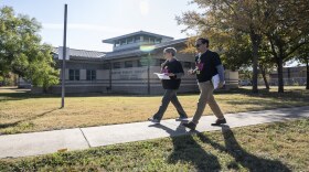 Jan Lance and Rene Lara prepare to knock on doors in Southeast Austin to collect stories about the state's health insurance coverage crisis. 