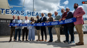 Community leaders and project developers pose with a ceremonial ribbon and scissors to commemorate the opening of Texas Health Mansfield Stadium July 1, 2026, in Mansfield.