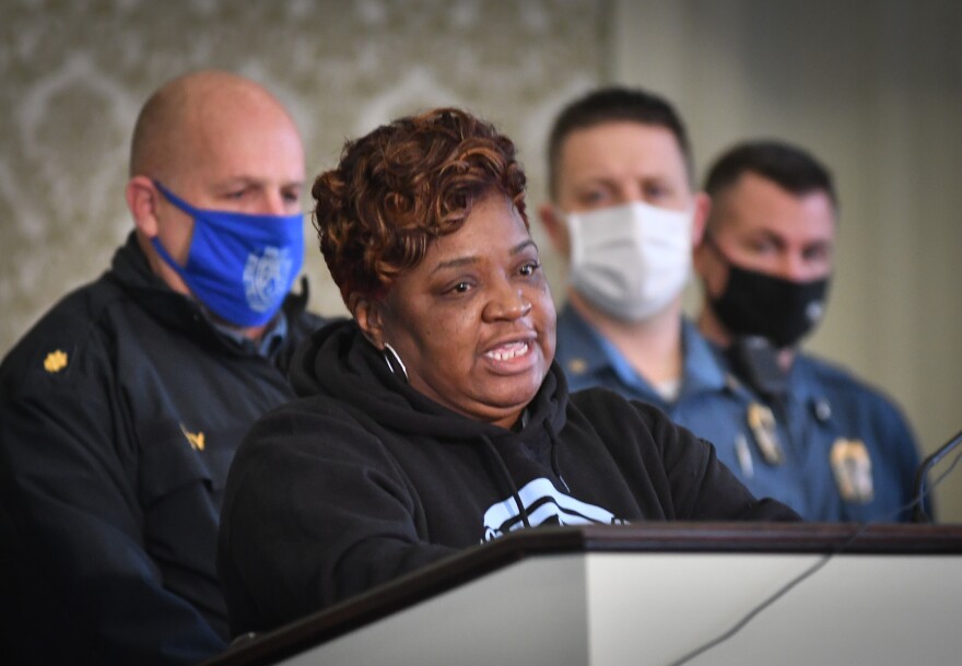 Rosilyn Temple, founder of KC Mothers in Charge, is flanked Friday by Kansas City Police officers as she encourages the public to not ignore the message of the Longest Night remembrance scheduled at Wornall Road Baptist Church for Monday.