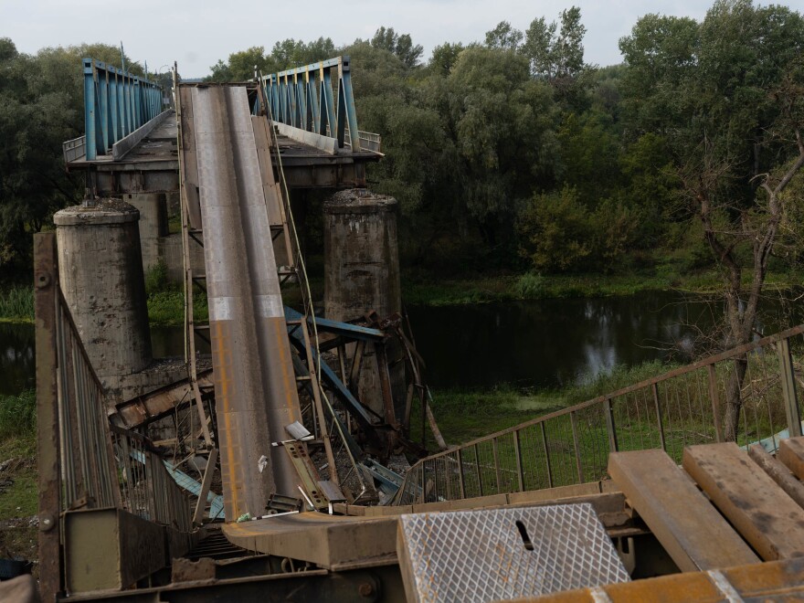 A collapsed bridge over a river in Izium. Ukrainian armed forces estimate 80% of the city is ruined from the violence.