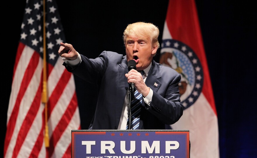 Republican Presidential candidate Donald Trump points to protesters that he tells to "get out," during his speech at the Peabody Opera House in St. Louis on March 11, 2016.