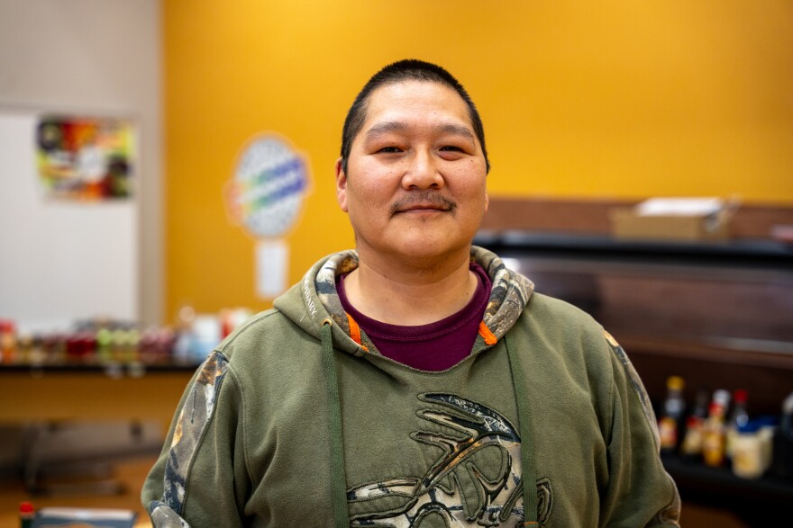 James Paul III poses for a photo in the cafeteria of Kipnuk's Chief Paul Memorial School on Oct. 19, 2025. Paul is one of a handful of residents racing to rebuild Kipnuk after the remnants of Typhoon Halong struck a week earlier.