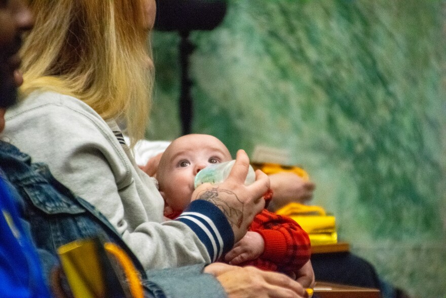One mother holds her baby, born sober during her participation in drug court, at the graduation on December 1, 2025. Many drug court participants give birth during the program or already have children at home.