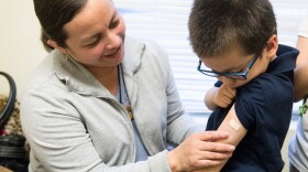 Luz Barajas took her son Carlos Cholico to get his flu shot at Crawford Kids Clinic in Aurora, Colo., last year. Health officials say there is some evidence the flu shot is more protective than the nasal flu vaccine.