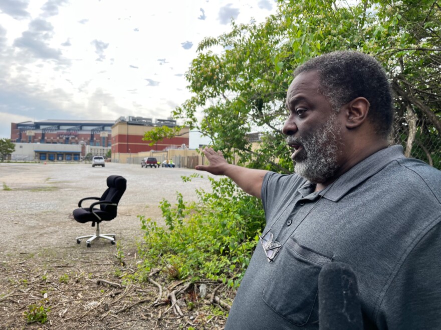 Historian Leon Bates points out over the former site of Greenlawn Cemetery. (Jill Sheridan/WFYI)