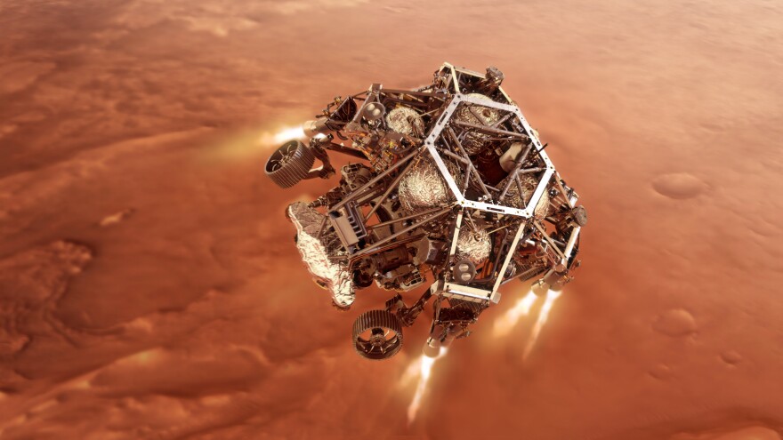 The descent stage carrying rover Perseverance fires its engines to land in Jezero Crater. Artist’s concept by NASA/JPL-Caltech