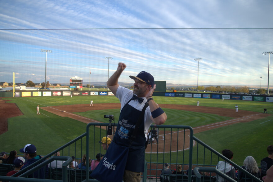 Erik the Peanut Guy in the stands behind home plate at Gesa Stadium pumping up the crowd.