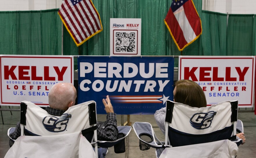 Supporters Ronnie and Linda Roberts wait for the start of the "Defend the Majority" rally for U.S. Sen. Kelly Loeffler, R-GA, and Sen. David Purdue, R-GA, with Sen. Tom Cotton, R-AR, at the Georgia National Fairgrounds and Agriculture Center on Nov. 19.