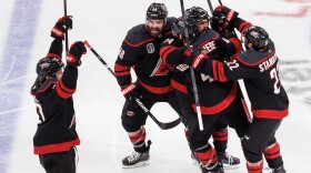 The Carolina Hurricanes players celebrate after the winning goal by Hurricanes' Seth Jarvis (24) against the Vegas Golden Knights during overtime in Game 2 of the NHL hockey Stanley Cup Final series in Raleigh, N.C., Thursday, June 4, 2026.