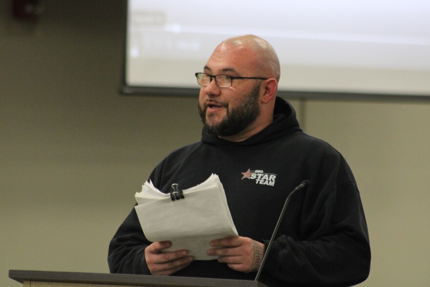 Aaron Andrews, a father whose kids attend OK Elementary School, presented board members with a petition against proposed school closures. He says the petition has between 600 and 700 signatures.