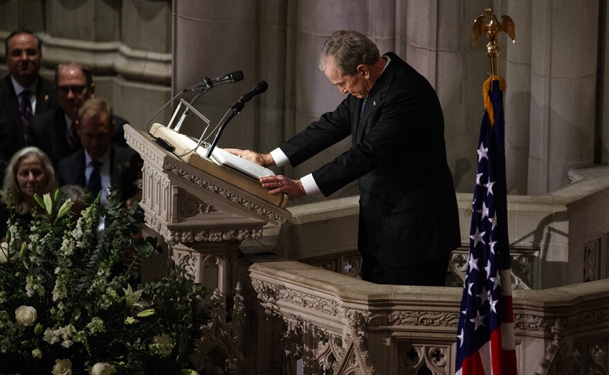 Former President George W. Bush fights back tears as he speaks during the State Funeral for his father, former President George H.W. Bush, at the National Cathedral, Wednesday, Dec. 5, 2018, in Washington.