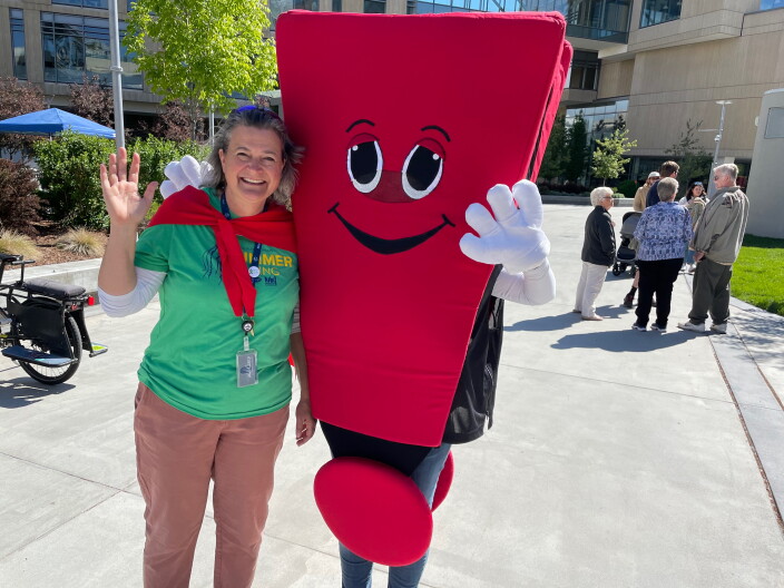 Director Jessica Dorr stands with the Boise Public Library mascot.