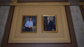 Portraits of former Govs. Mitch Daniels, left, and Joe Kernan hang side by side at the Indiana Statehouse as part of a new display intended to make the paintings more accessible to visitors.