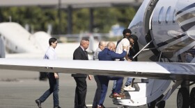 Harjinder Singh is escorted onto an airplane by Florida Lt. Gov. Jay Collins and law enforcement on Thursday, Aug. 21, 2025, in Stockton, Calif. (AP Photo/Benjamin Fanjoy)