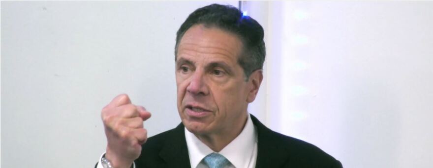 A headshot of former Gov. Andrew Cuomo making a fist.