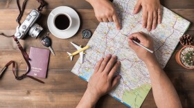 Young couple planning vacation trip with map.