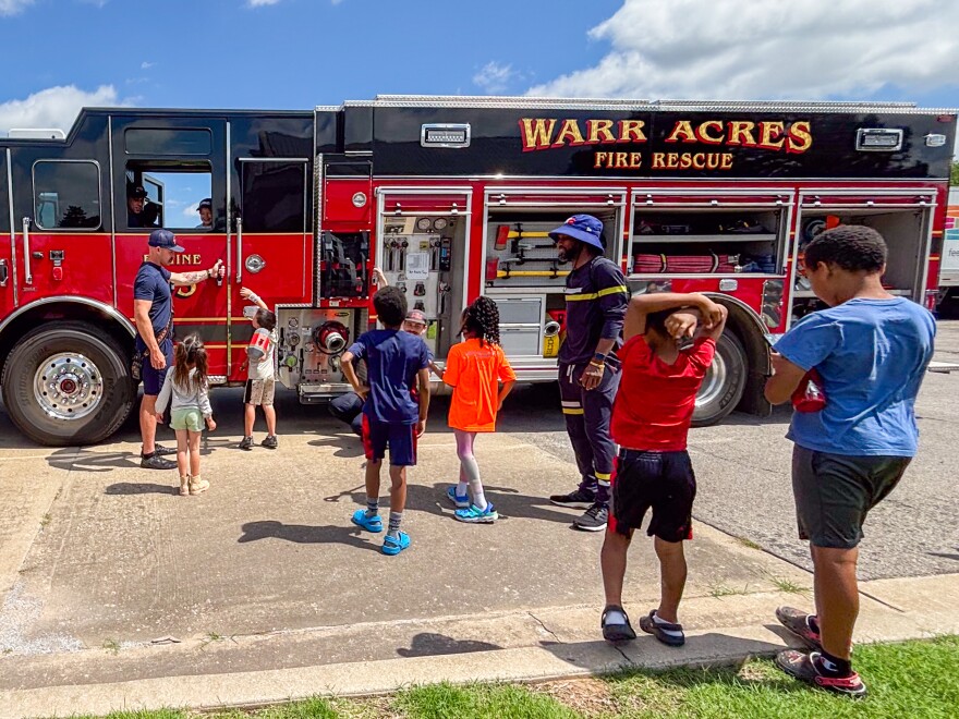 Firefighters from Warr Acres Fire Department let kids experience the mysteries of a firetruck at the Putnam City Schools CAST Resource Rally in Oklahoma City on June 3, 2025.