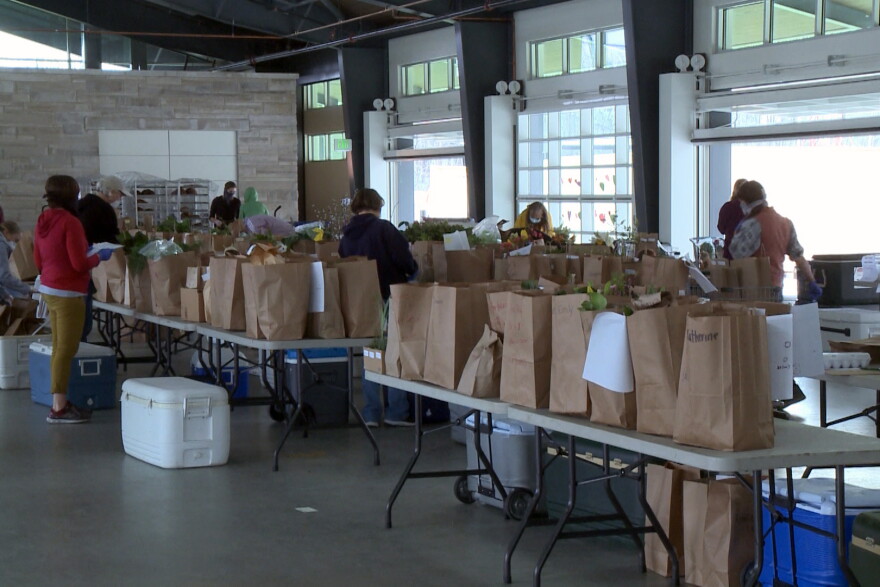 Volunteers prepared produce and delivered them to each patron's vehicle.