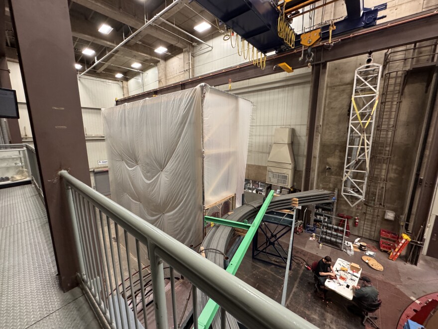 One mirror for the Giant Magellan Telescope standing under scaffolding.