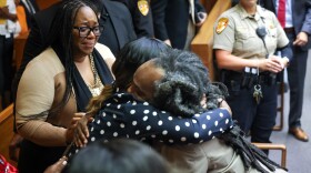 Benjamin Cole embraces his mother after a judge ordered authorities to release him from prison. His sister, Britney Pearson-Norfleet (left) watches emotionally.