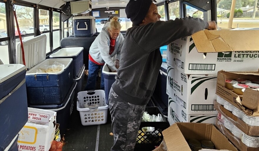 The Children's Table volunteers prepare for mobile food distributions on the rural food bank bus.