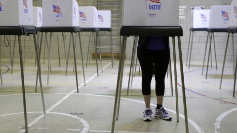 A woman casts her vote at a polling place inside Winfield Elementary School's gym in Windsor Mill, Md., during the state's 2016 primary.