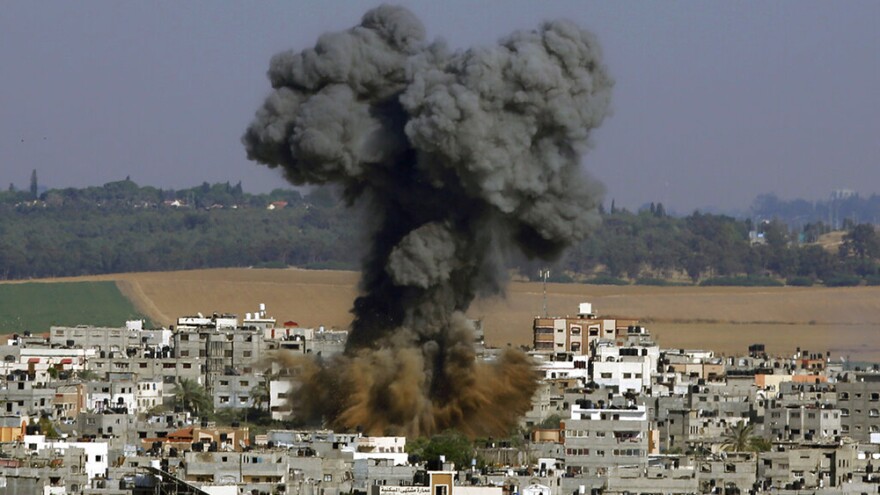 FILE - In this May 11, 2021, file photo, smoke rises after an Israeli airstrike in Gaza City. Israel is at war with Hamas, Jewish-Arab mob violence has erupted inside Israel, and the West Bank is experiencing its deadliest unrest in years.