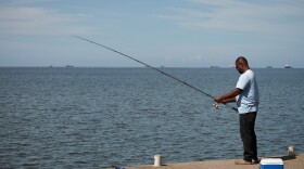 A man fishes in Cocorite, Trinidad and Tobago, Friday, Oct. 3, 2025. (AP Photo/Anselm Gibbs)