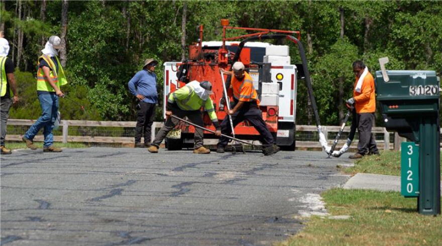 Road crews seal cracks in pavement in Pine Ridge, Fla., May 21, 2026. Crack sealing is used to maintain existing pavement and help extend the life of the road.