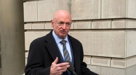 Sen. Mark Kelly, D-Ariz., speaks with reporters Feb. 3, 2026, outside the federal courthouse in Washington, D.C.