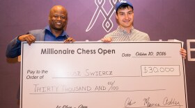 GM Maurice Ashley presents a ceremonial check to Dariusz Swiercz. 