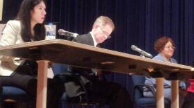 DPS EM Steven Rhodes, center, takes notes at a meeting with Detroit's elected school board.