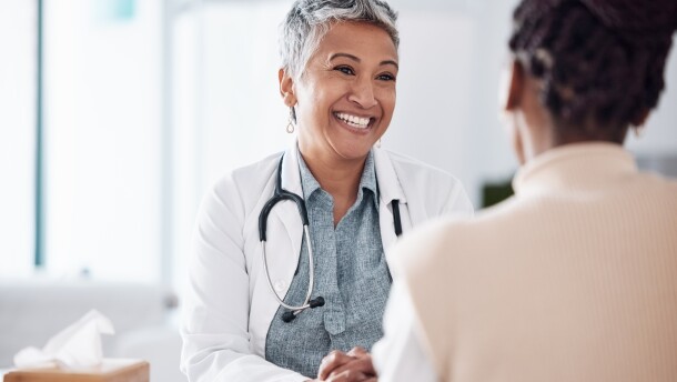 Happy, mature or doctor consulting a patient in meeting in hospital for healthcare help, feedback or support. People, medical or nurse with black woman talking or speaking of test results or advice.