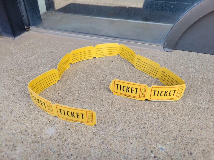 A strip of yellow tickets on a countertop