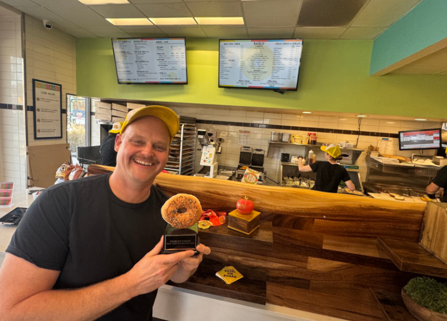 Baltik’s Bagel owner Yero Rudzinskas holds his 'People's Choice' award after a big with at the 2025 New York Bagelfest