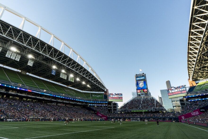 Fans watch the first half of an attendance record-breaking NWSL soccer match at Lumen Field between the OL Reign and the Washington Spirit, Friday, Oct. 6, 2023, in Seattle.