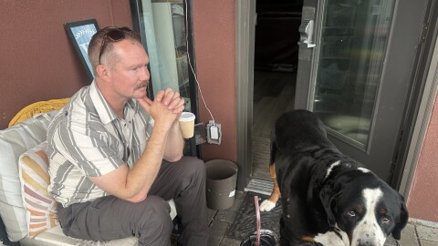 Aspen Fire Chief Jake Andersen takes a break on his back porch near the Aspen Airport Business Center on July 9, 2026. His dog, affectionately named “Tug Boat,” keeps him company.