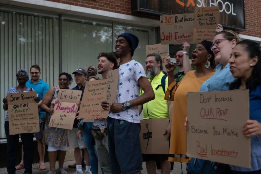 Tenant union members pose for a photo after their rally in front of Ocean Management's office. They delivered a signed letter stating they refused the rent increases.